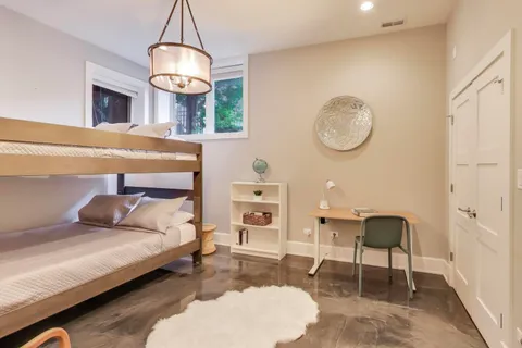 a view of a patio with table and chairs potted plants and a large tree