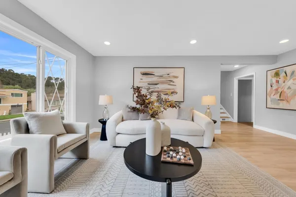 a living room with furniture and a large window