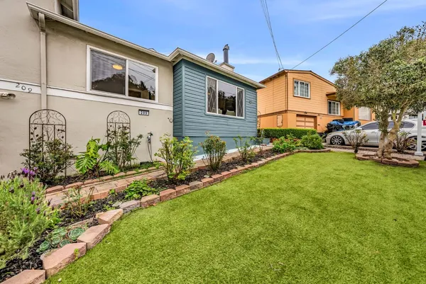 a front view of a house with garden