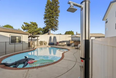 a open kitchen with stainless steel appliances granite countertop sink stove and white cabinets with wooden floor