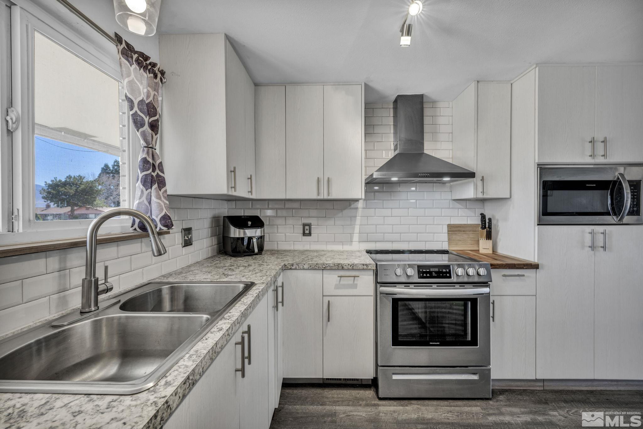 12060 Broken Hill Road Reno, NV 89511 - Photo 6 of 21 a kitchen with a sink stove and cabinets
