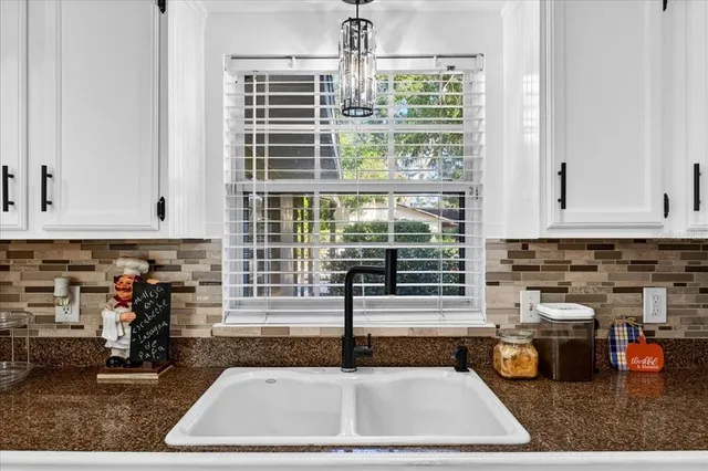 a kitchen with sink refrigerator and window