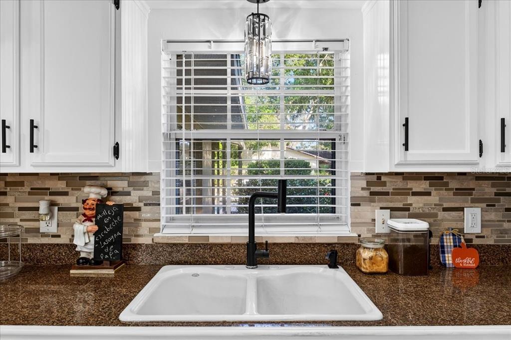 1501 North Combee Road Lakeland, FL 33801 - Photo 11 of 34 a kitchen with sink refrigerator and window