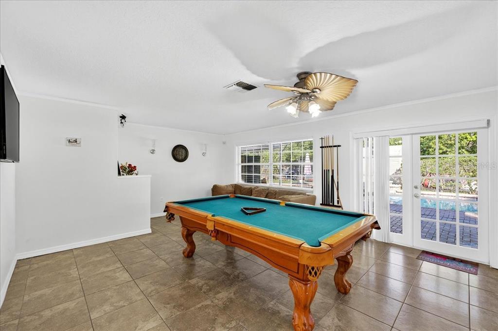 1501 North Combee Road Lakeland, FL 33801 - Photo 13 of 34 a room with pool table and a ceiling fan