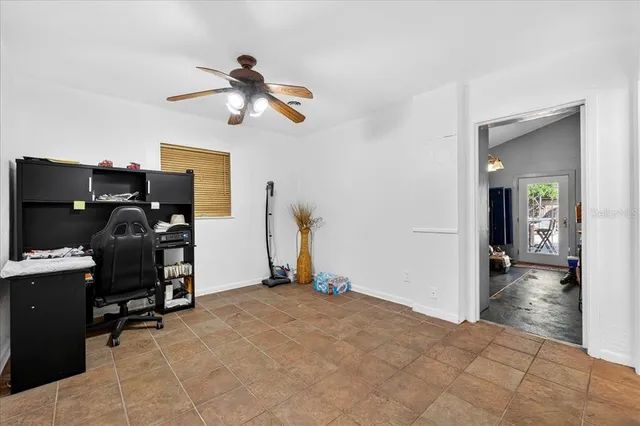 a view of a workspace with furniture and a window