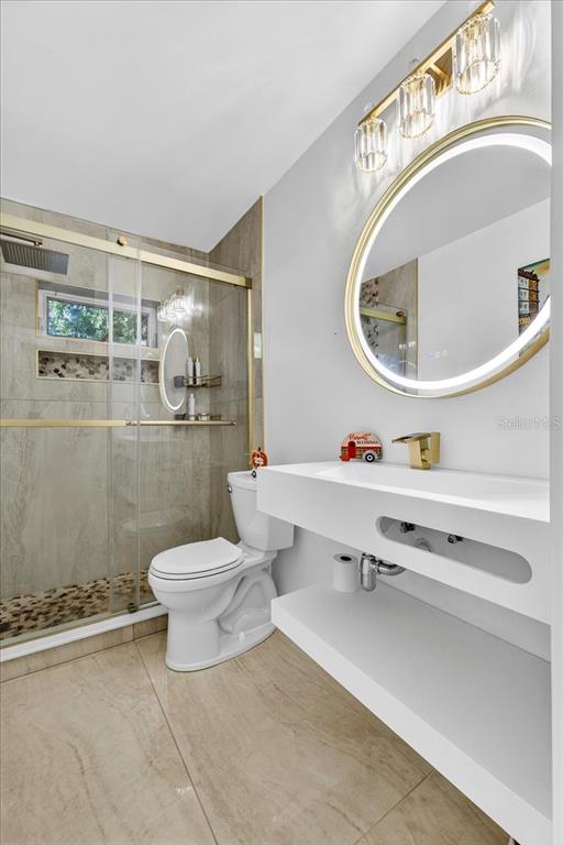 1501 North Combee Road Lakeland, FL 33801 - Photo 28 of 34 a bathroom with a toilet a sink and mirror