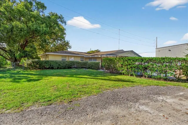 a view of a house with a yard and a garden