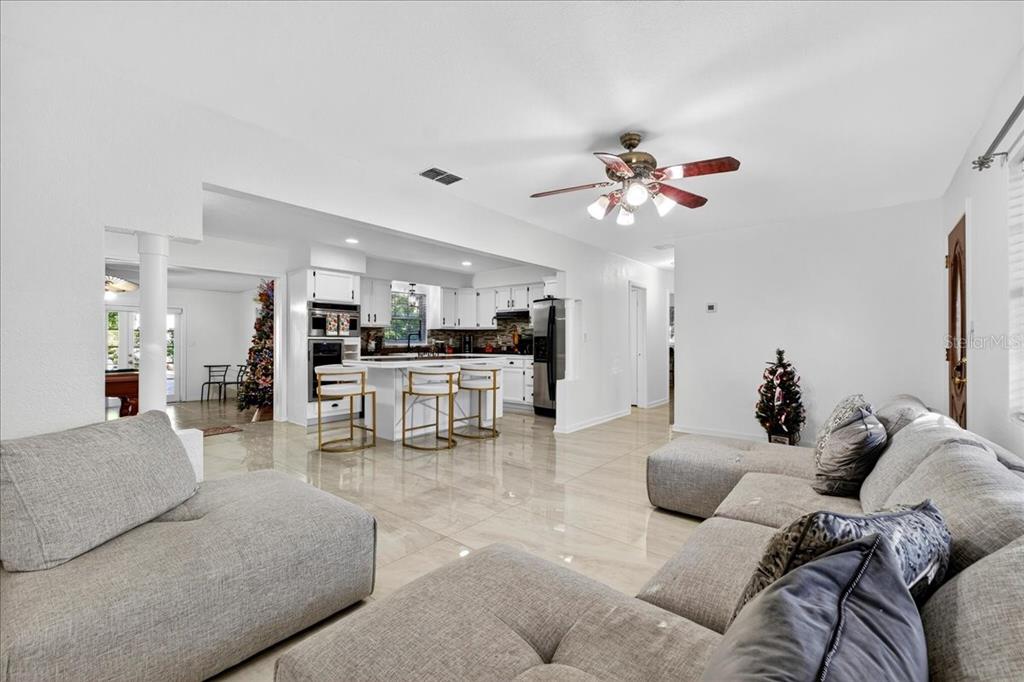 1501 North Combee Road Lakeland, FL 33801 - Photo 7 of 34 a living room with furniture and kitchen view
