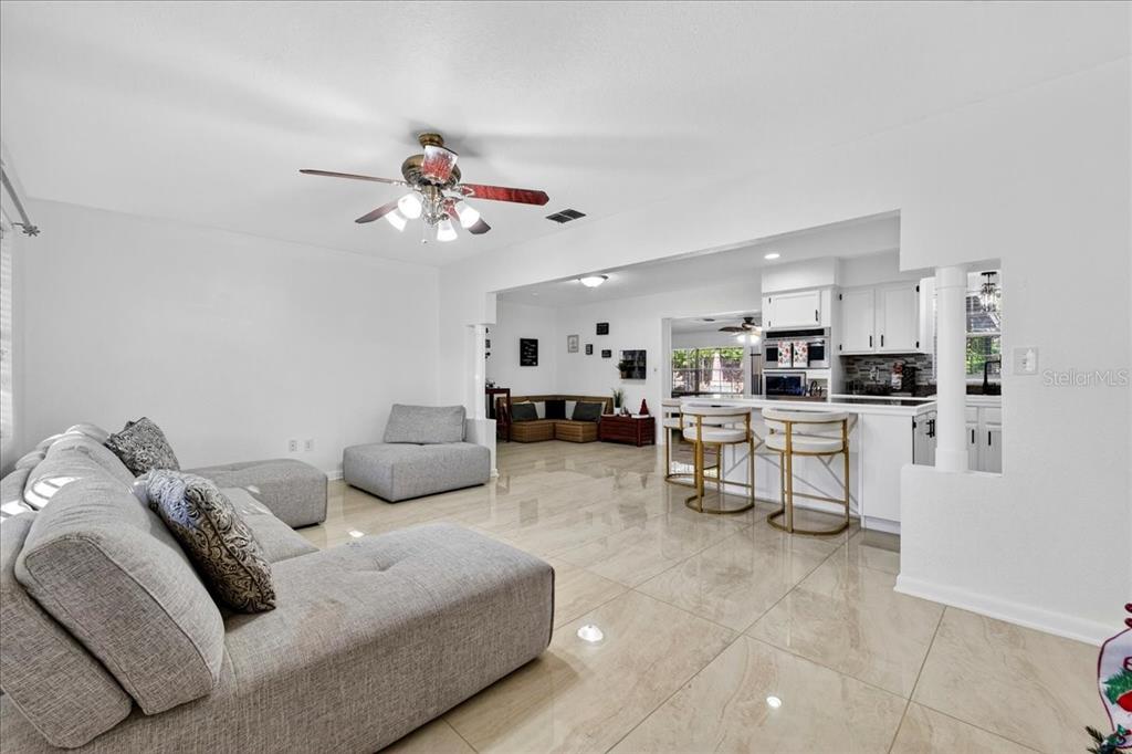 1501 North Combee Road Lakeland, FL 33801 - Photo 8 of 34 a living room with furniture and kitchen view