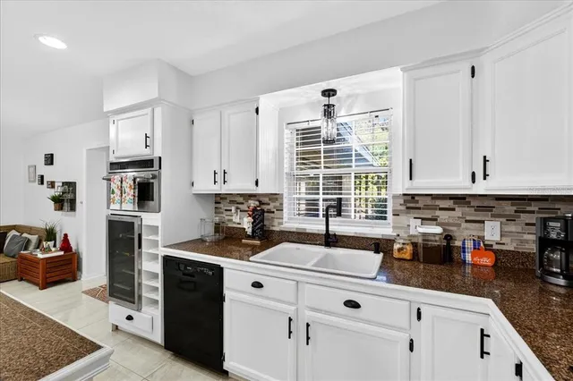 a kitchen with stainless steel appliances granite countertop a sink stove and cabinets