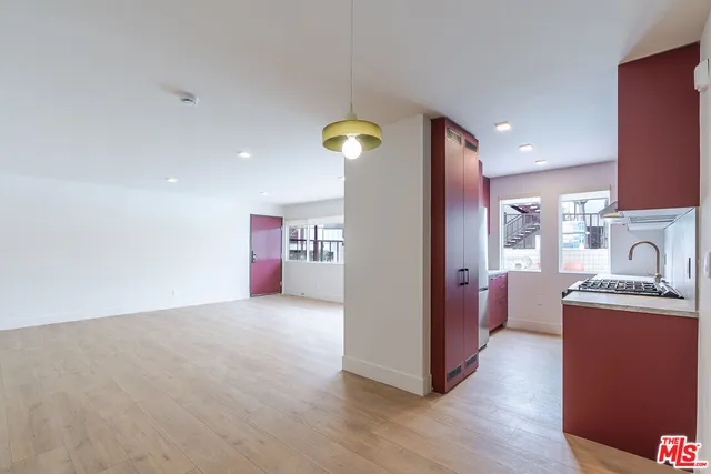 a open kitchen with stainless steel appliances granite countertop a refrigerator and a stove top oven