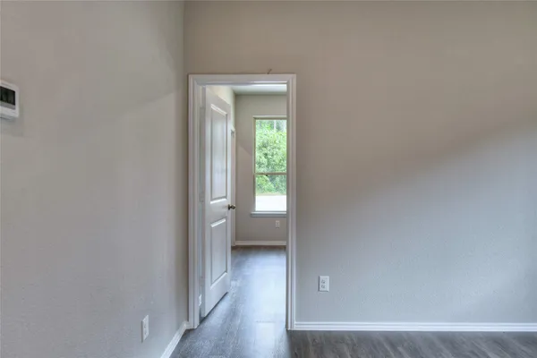 a view of an empty room and a window