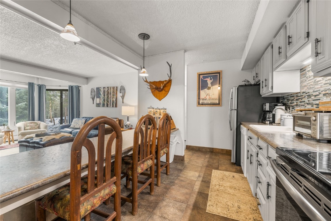 1179 Ski Hill Road, Unit 147 Breckenridge, CO 80424 - Photo 12 of 43 a kitchen with stainless steel appliances granite countertop a lot of cabinets a stove and a sink