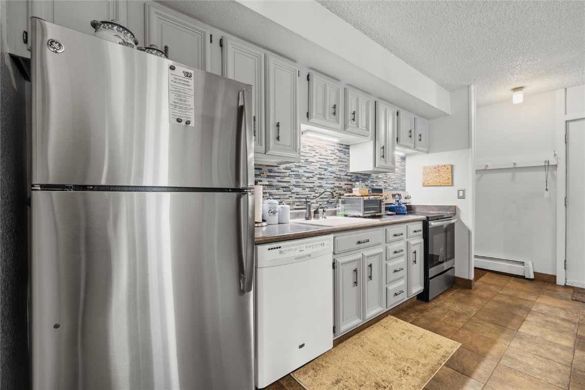 1179 Ski Hill Road, Unit 147 Breckenridge, CO 80424 - Photo 13 of 43 a kitchen with stainless steel appliances a refrigerator sink and cabinets