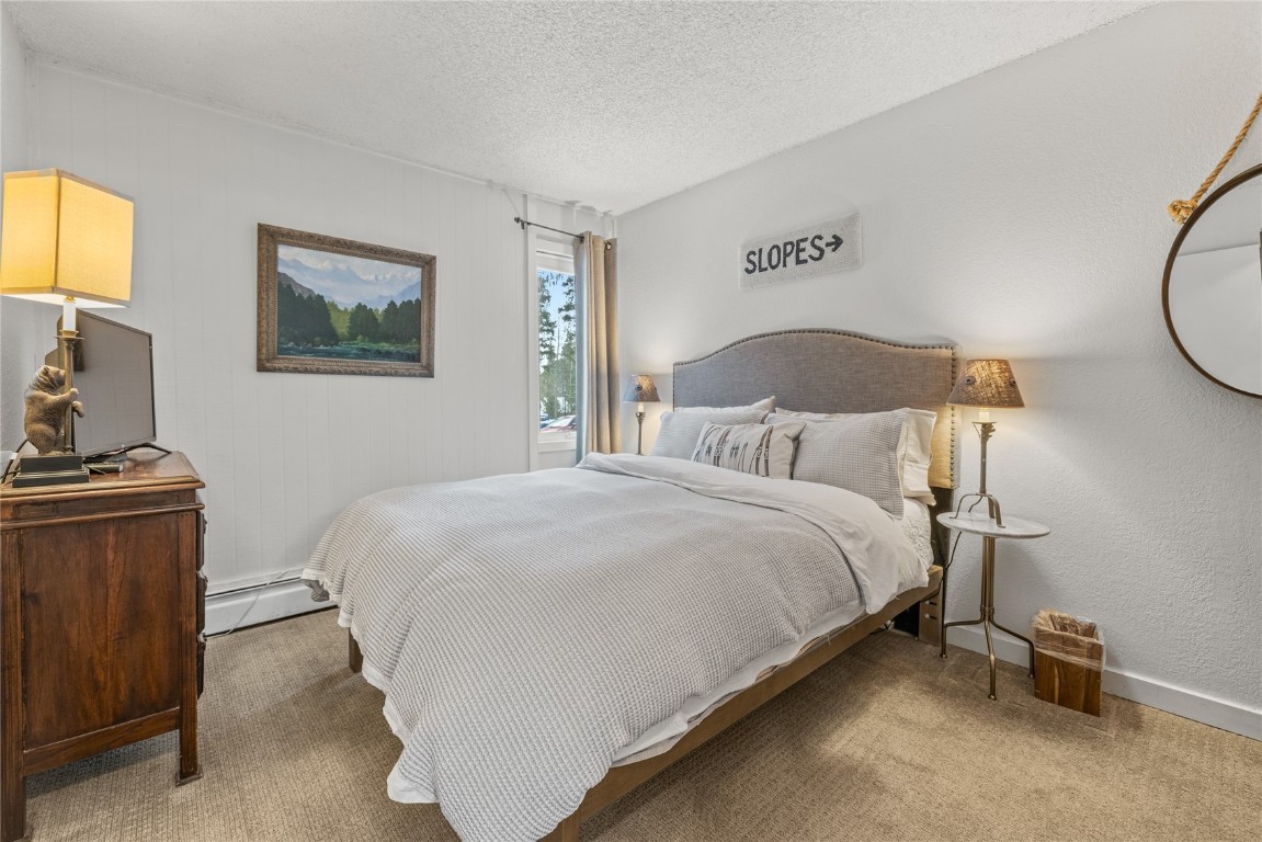 1179 Ski Hill Road, Unit 147 Breckenridge, CO 80424 - Photo 15 of 43 a bedroom with a bed and a tv