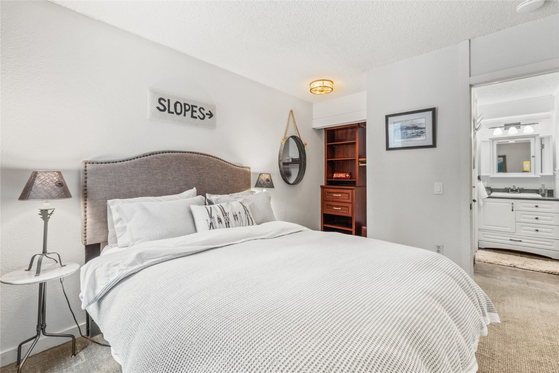 1179 Ski Hill Road, Unit 147 Breckenridge, CO 80424 - Photo 17 of 43 a bedroom with a large bed and a closet