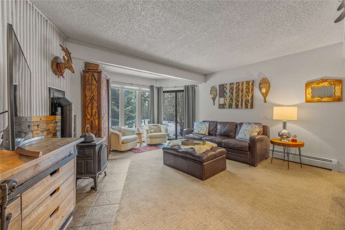 1179 Ski Hill Road, Unit 147 Breckenridge, CO 80424 - Photo 2 of 43 a living room with furniture and a large window