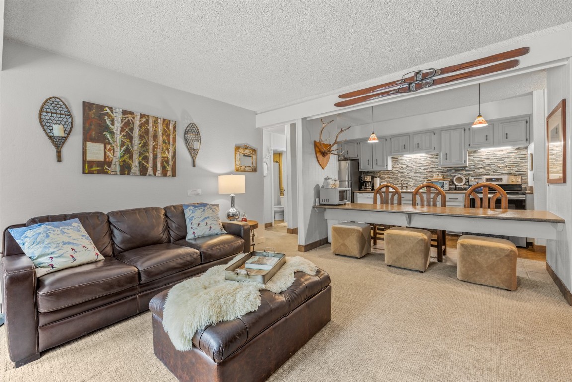 1179 Ski Hill Road, Unit 147 Breckenridge, CO 80424 - Photo 4 of 43 a living room with furniture and view of kitchen