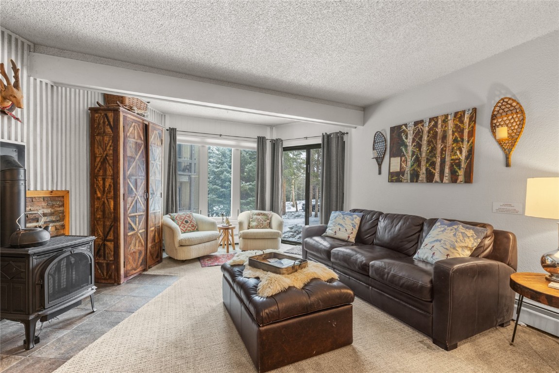 1179 Ski Hill Road, Unit 147 Breckenridge, CO 80424 - Photo 5 of 43 a living room with furniture and a large window