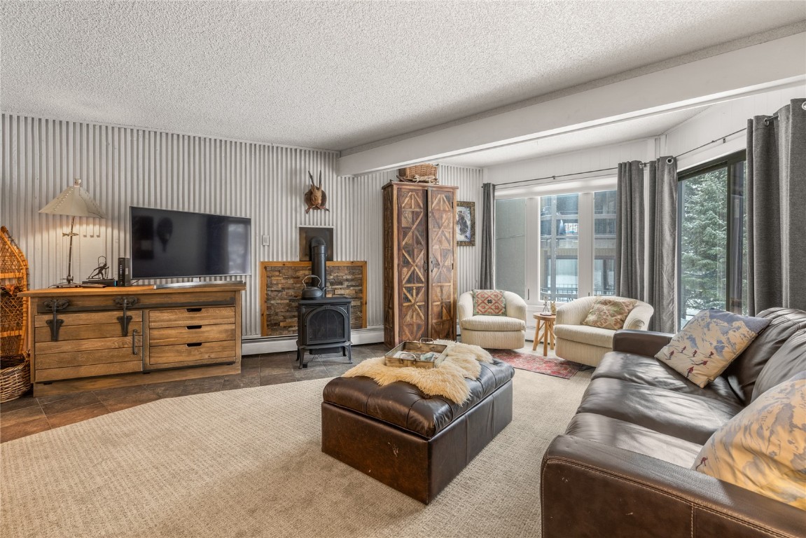 1179 Ski Hill Road, Unit 147 Breckenridge, CO 80424 - Photo 7 of 43 a living room with furniture and a flat screen tv