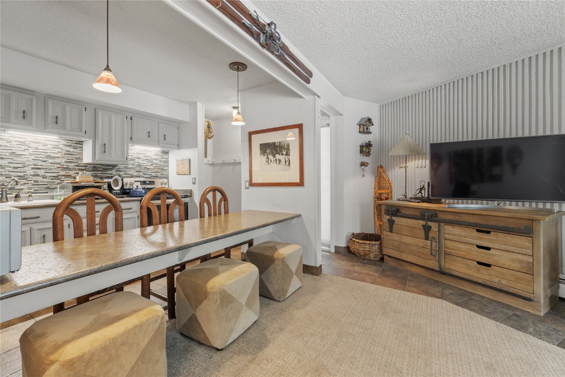 1179 Ski Hill Road, Unit 147 Breckenridge, CO 80424 - Photo 8 of 43 a living room with furniture and a flat screen tv