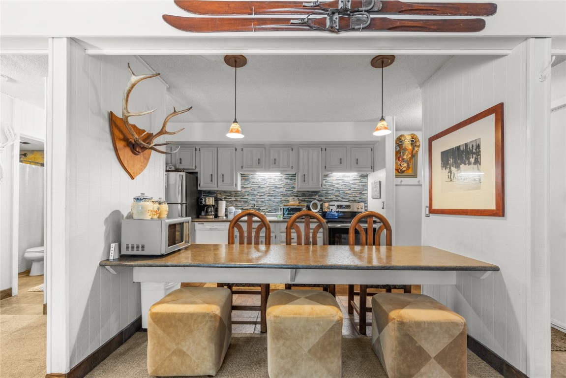1179 Ski Hill Road, Unit 147 Breckenridge, CO 80424 - Photo 9 of 43 a dining room with furniture and chandelier