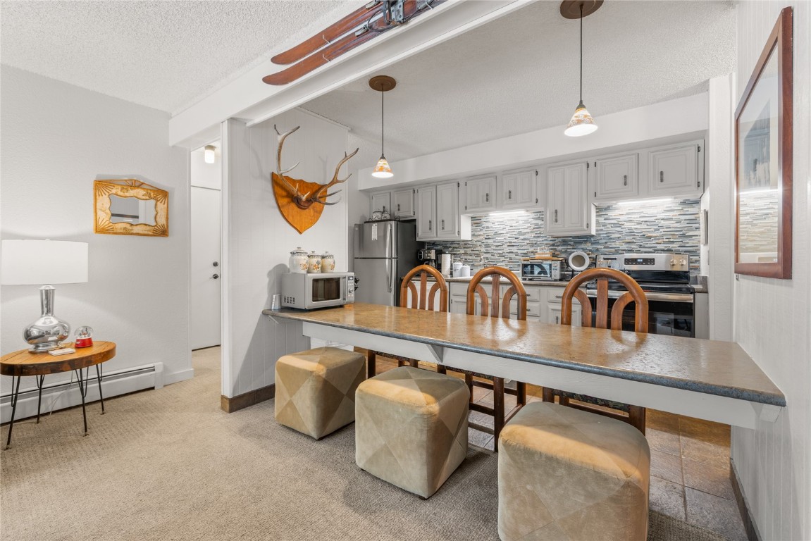 1179 Ski Hill Road, Unit 147 Breckenridge, CO 80424 - Photo 10 of 43 a kitchen with stainless steel appliances granite countertop a sink a stove and a wooden floors