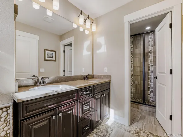 a bathroom with a double vanity sink and a mirror