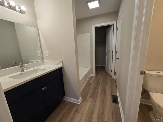 a bathroom with a sink a mirror and a toilet