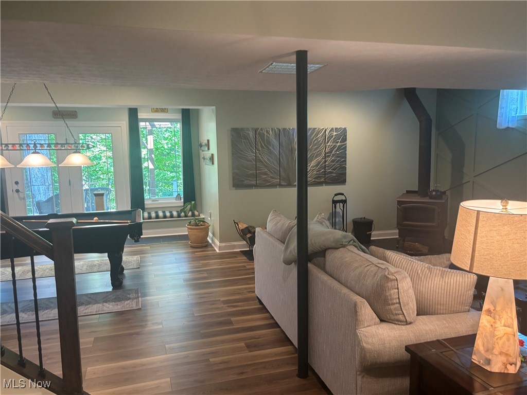 5232 Emerson Road Madison, OH 44057 - Photo 25 of 48 Family room with a wood stove, dark wood finished floors, and billiards table