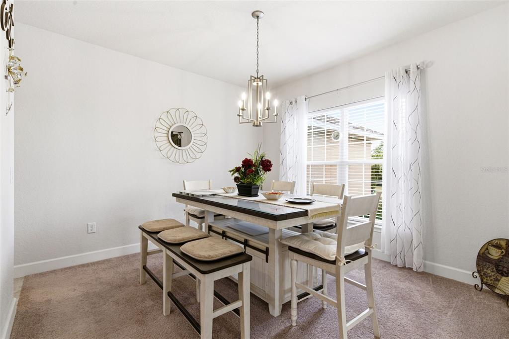 12181 Topaz Street Spring Hill, FL 34608 - Photo 12 of 71 a view of a dining room with furniture and chandelier