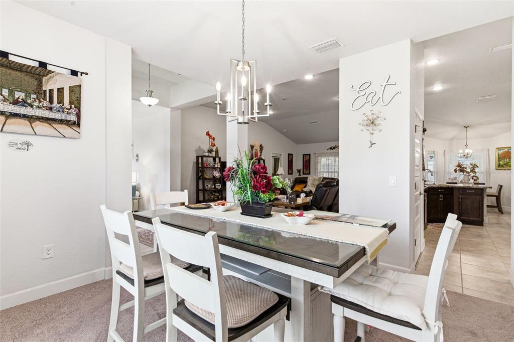 12181 Topaz Street Spring Hill, FL 34608 - Photo 13 of 71 a view of a dining room with furniture and chandelier