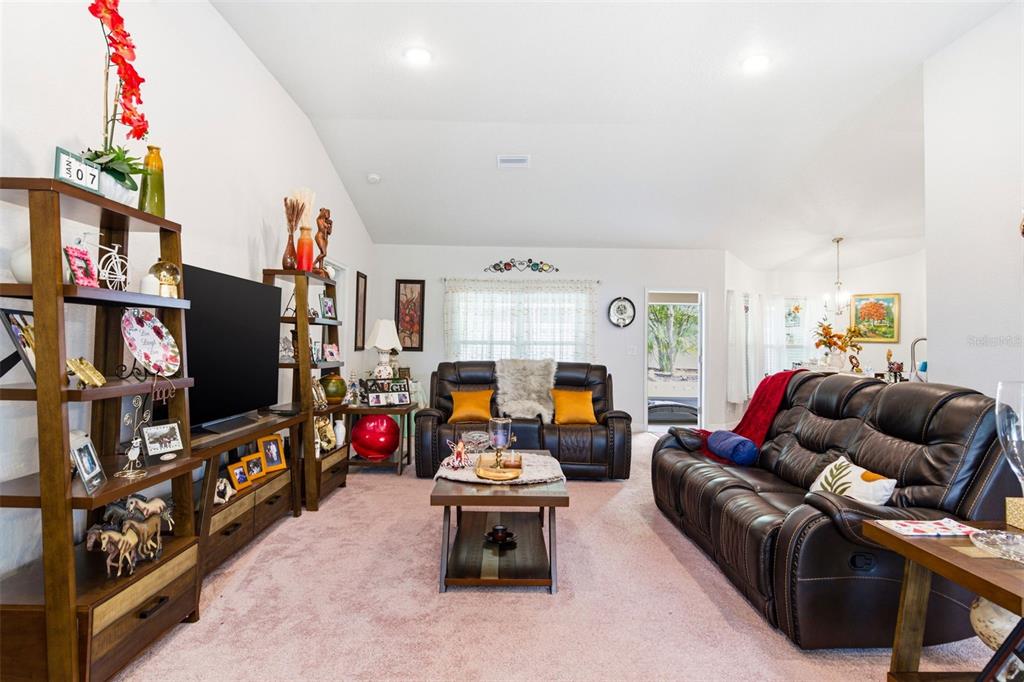 12181 Topaz Street Spring Hill, FL 34608 - Photo 16 of 71 a living room with furniture and a flat screen tv
