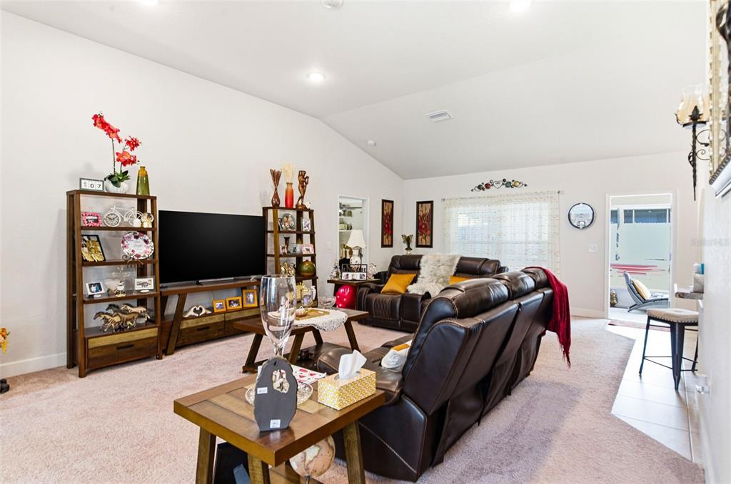 12181 Topaz Street Spring Hill, FL 34608 - Photo 17 of 71 a living room with furniture and a flat screen tv