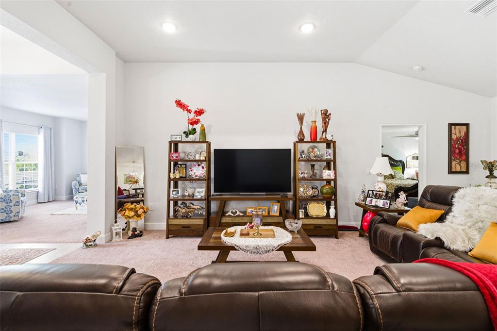 12181 Topaz Street Spring Hill, FL 34608 - Photo 20 of 71 a living room with furniture and a flat screen tv