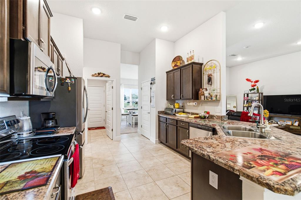 12181 Topaz Street Spring Hill, FL 34608 - Photo 22 of 71 a kitchen with stainless steel appliances granite countertop a stove oven and a refrigerator