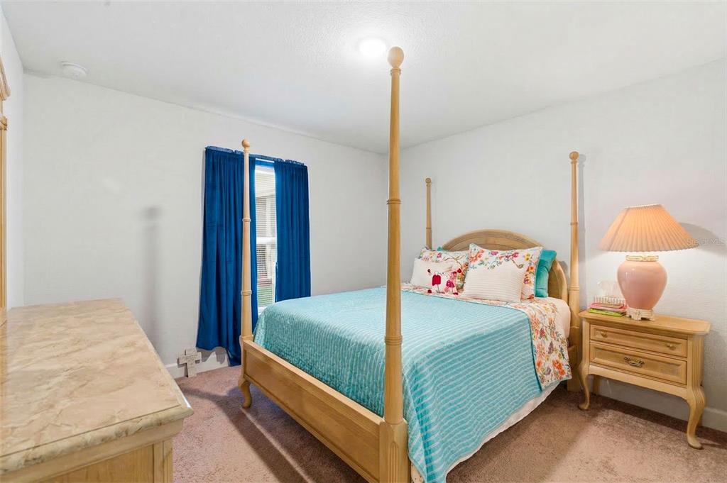 12181 Topaz Street Spring Hill, FL 34608 - Photo 28 of 71 a bedroom with a bed and large window