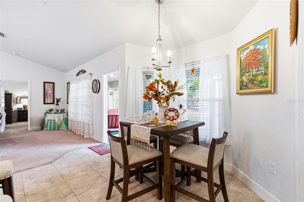 12181 Topaz Street Spring Hill, FL 34608 - Photo 32 of 71 a view of a dining room with furniture and a chandelier