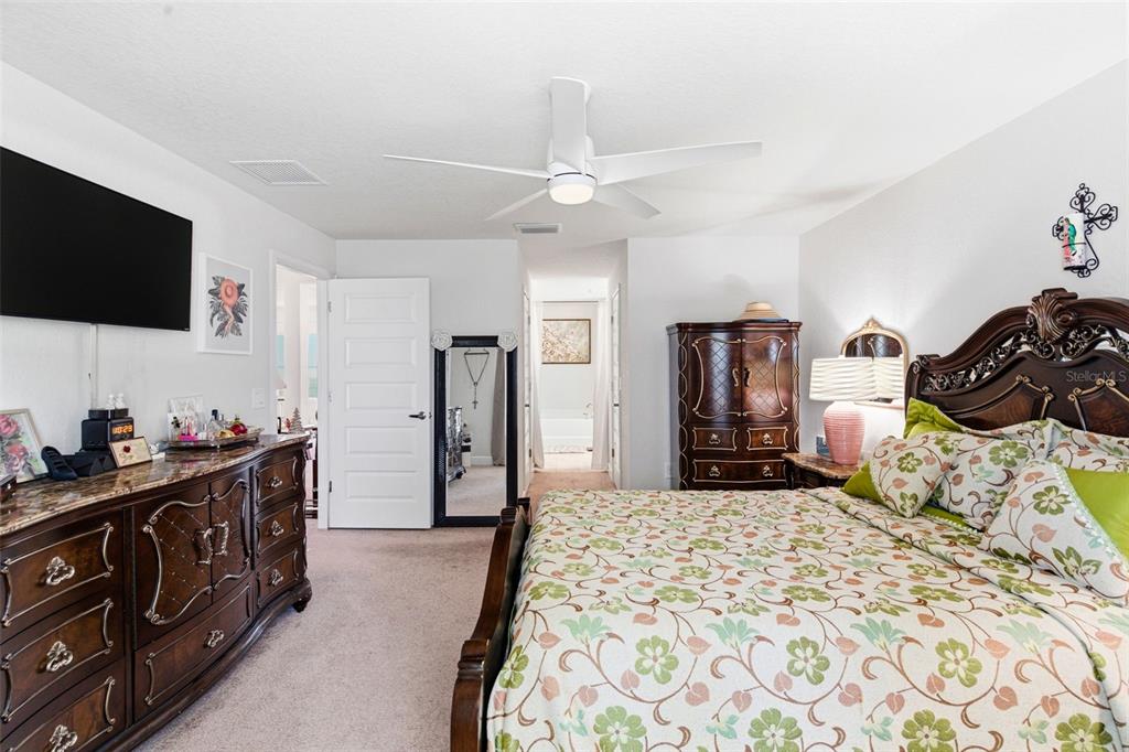 12181 Topaz Street Spring Hill, FL 34608 - Photo 35 of 71 a bedroom with a bed and a flat tv screen on dresser