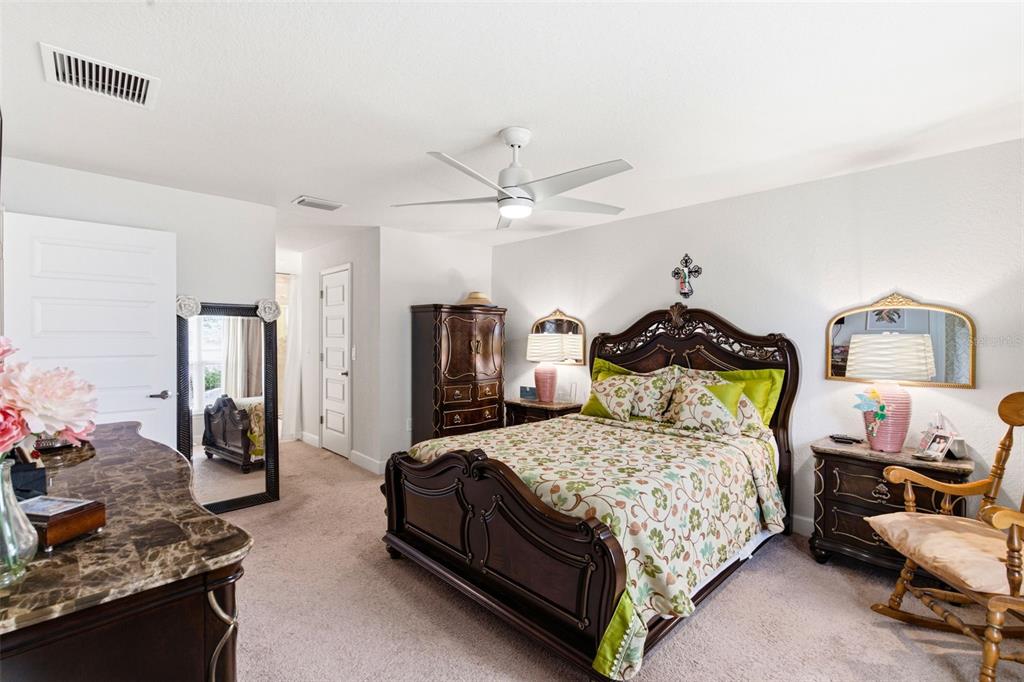 12181 Topaz Street Spring Hill, FL 34608 - Photo 36 of 71 a bedroom with a bed a couch and a potted plant