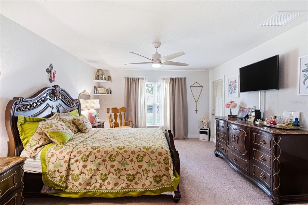 12181 Topaz Street Spring Hill, FL 34608 - Photo 37 of 71 a bedroom with a bed and a flat screen tv