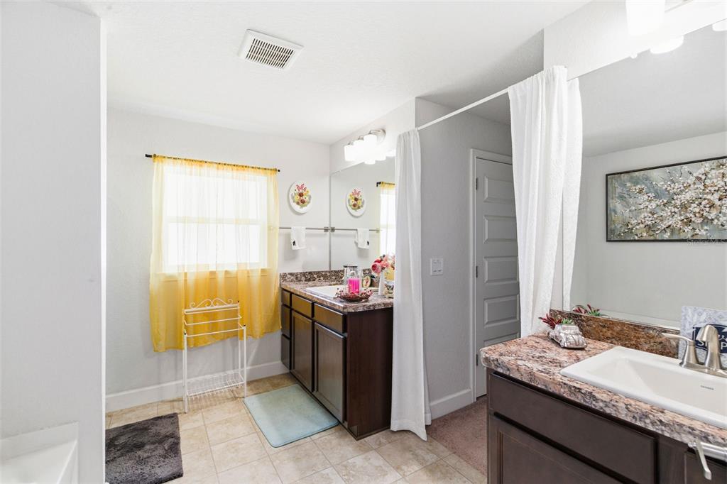 12181 Topaz Street Spring Hill, FL 34608 - Photo 39 of 71 a bathroom with a granite countertop sink and a mirror