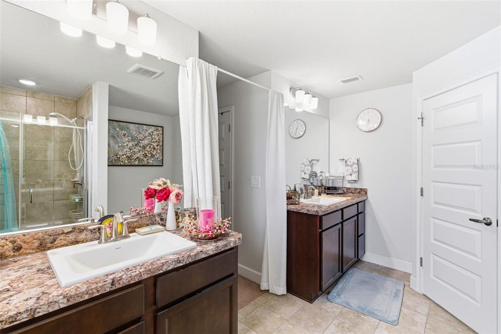 12181 Topaz Street Spring Hill, FL 34608 - Photo 40 of 71 a bathroom with a granite countertop sink and a mirror