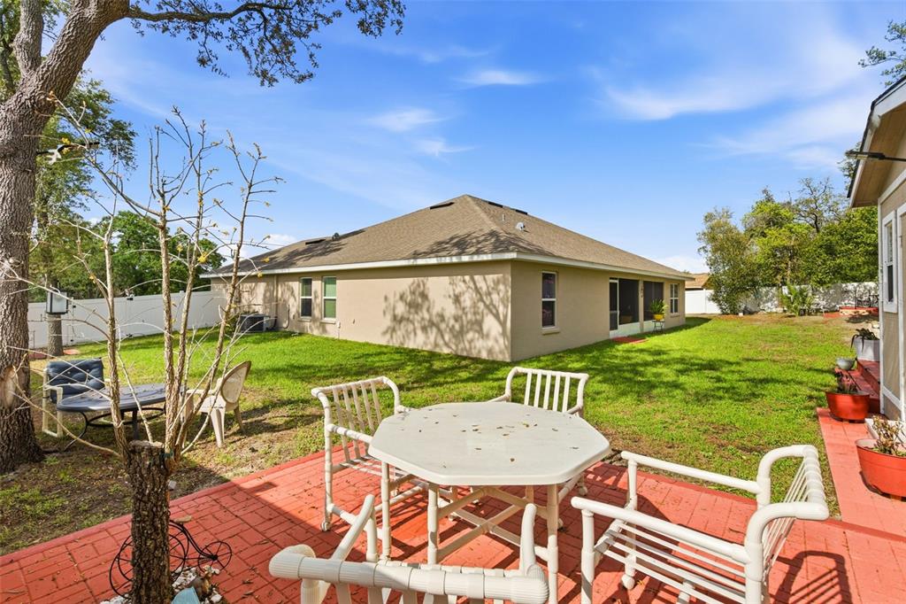 12181 Topaz Street Spring Hill, FL 34608 - Photo 46 of 71 a view of a house with backyard and a patio