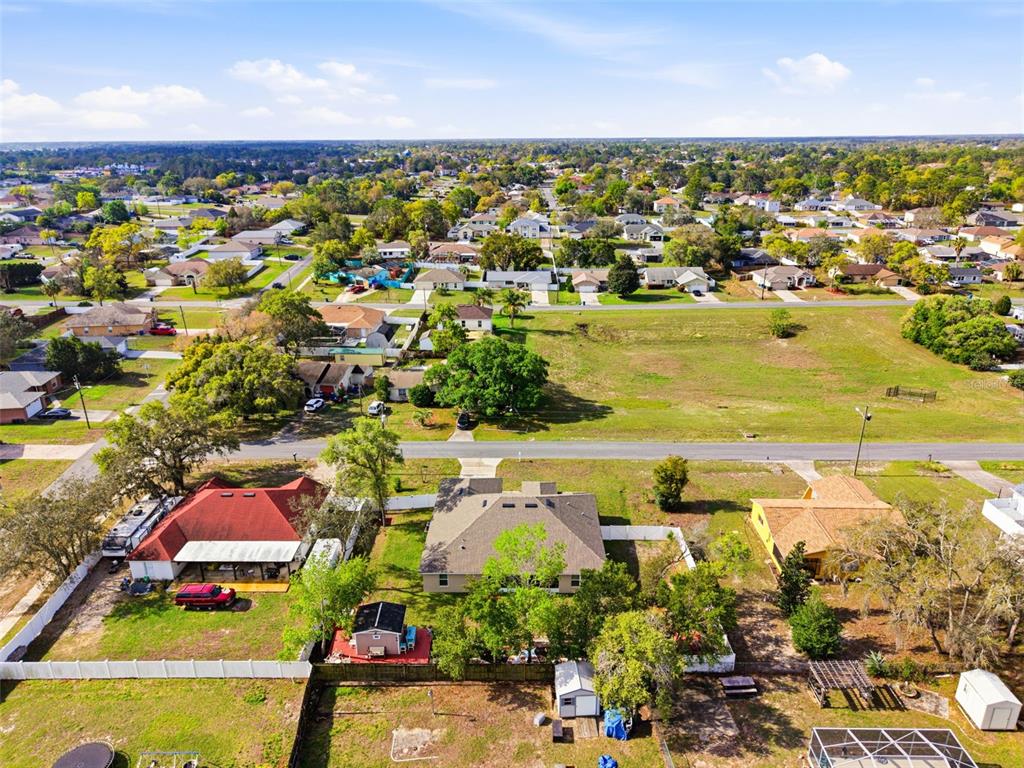 12181 Topaz Street Spring Hill, FL 34608 - Photo 60 of 71 an aerial view of residential houses with outdoor space and trees