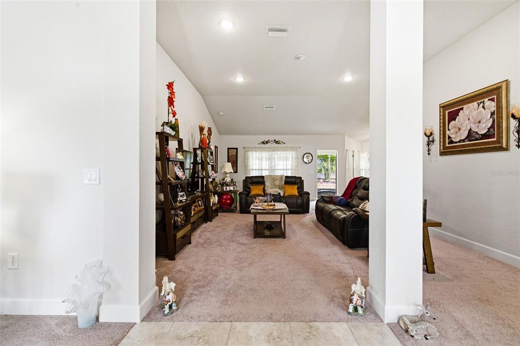 12181 Topaz Street Spring Hill, FL 34608 - Photo 6 of 71 a living room with furniture and a gym machine