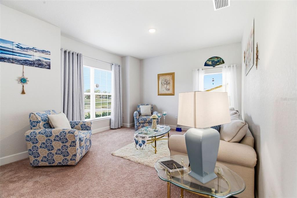 12181 Topaz Street Spring Hill, FL 34608 - Photo 9 of 71 a living room with furniture and a large window