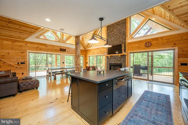 a kitchen with stainless steel appliances granite countertop a stove a refrigerator a oven a sink with a dining table and chairs