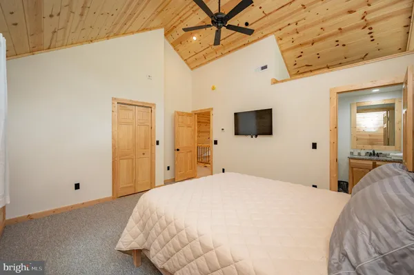 a spacious bedroom with a bed and a window