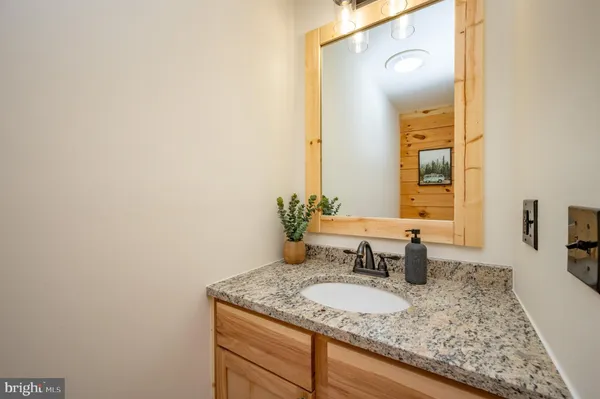 a bedroom with a bed and a ceiling fan